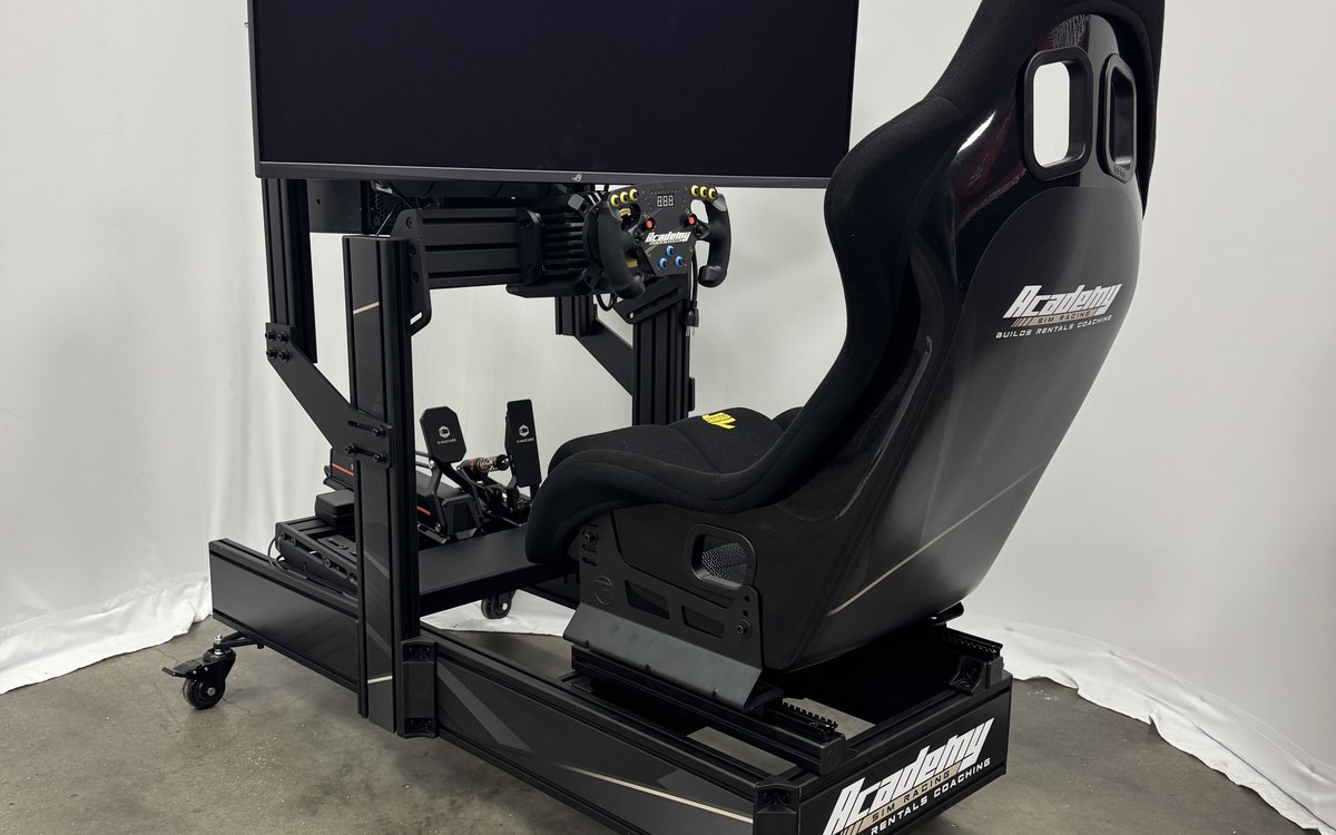 The Academy Sim Racing simulator at Superior Autohaus in Bonita Springs — direct-drive wheel, Simucube pedals and a curved ultrawide screen